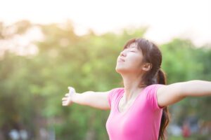Woman stetches out soaking the energy of the sun