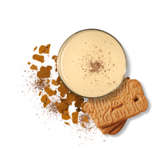 cookie butter beverage in a glass surrounded by cookies and cookie crumbs